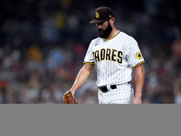 Sep 3, 2021; San Diego, California, USA; San Diego Padres starting pitcher Jake Arrieta (49) walks to the dugout after the last out of the top the fifth inning against the Houston Astros at Petco Park.